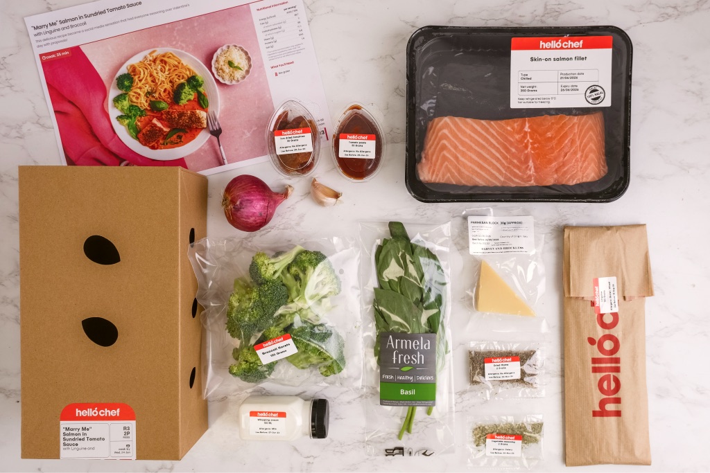A Hello Chef box unpacked: salmon, vegetables and a recipe card laid out