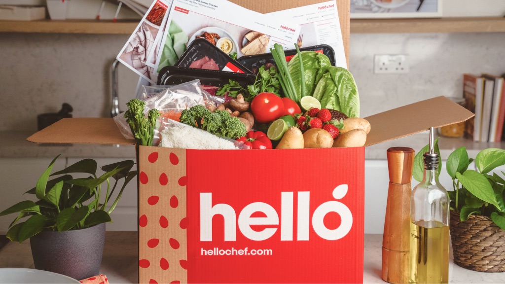 An open Hello Chef box overflowing with fresh vegetables