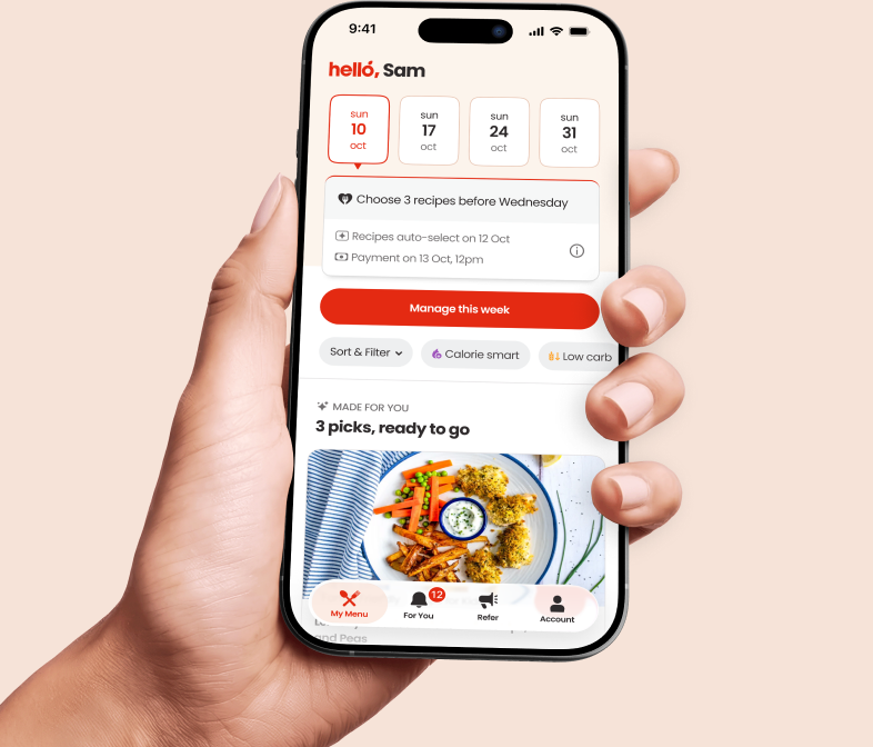 A hand holding a phone showing the Hello Chef app