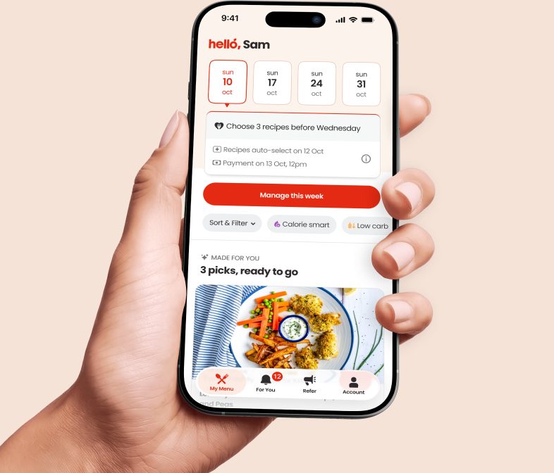 A hand holding a phone showing the Hello Chef app